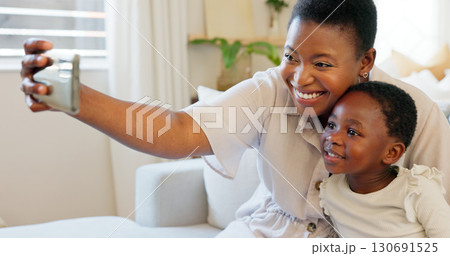 Happy, selfie and mother with girl child on sofa at home with love, hug and care, bond or memory. Smartphone, smile and black family in living room for parent influencer, podcast or profile picture Happy, selfie and mother with girl child on sofa at home with love, hug and care, bond or memory. Smartphone, smile and black family in living room for parent influencer, podcast or profile picture 130691525