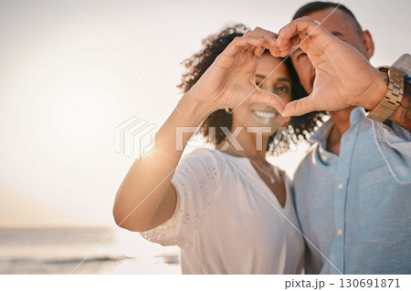 Love, couple and heart hands at beach on vacation, smile or having holiday fun. Ocean sunset, interracial romance and happy man and woman with affection emoji or gesture for care, trust or commitment Love, couple and heart hands at beach on vacation, smile or having holiday fun. Ocean sunset, interracial romance and happy man and woman with affection emoji or gesture for care, trust or commitment 130691871
