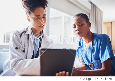 Tablet, black people or nurses reading news, medical research or tests results in hospital together. Teamwork, digital media or African doctors planning or speaking of healthcare report on website 130691876