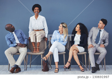 Business people, hiring and waiting room of woman standing out against wall for interview, meeting or opportunity. Group of diverse interns looking at African American female candidate in recruitment 130691997