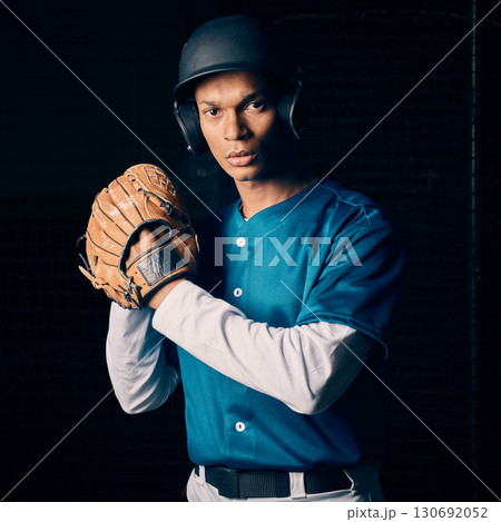 Baseball player, black man and studio portrait with focus, vision and balance for sport, fitness and motivation. Sports, exercise and training with goals, contest or competition by dark background 130692052