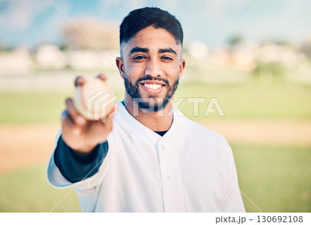 Baseball player, portrait and sportsman holding ball on match or game day on a sports field or pitch feeling happy. Sport, athlete and pitcher at training with a smile due to health and wellness Baseball player, portrait and sportsman holding ball on match or game day on a sports field or pitch feeling happy. Sport, athlete and pitcher at training with a smile due to health and wellness 130692108