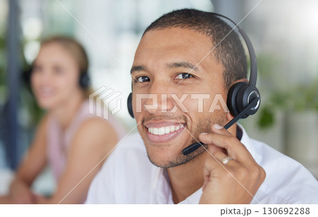 Smile, headset and portrait of a man in a call center for online support, consulting and advice. Happy, conversation and face of a customer service agent working in telemarketing, sales and helpline 130692288