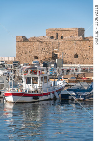 Fishing boat moored near Paphos castle in Cyprus harbour on sunny day 130692318
