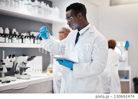 Science, research and black man test tube and tablet for medical analysis and innovation in laboratory. Pharmaceutical analytics, medicine study and scientist in South Africa checking vaccine results Science, research and black man test tube and tablet for medical analysis and innovation in laboratory. Pharmaceutical analytics, medicine study and scientist in South Africa checking vaccine results 130692474