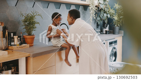 Family, love or playing with a girl and mother laughing together in the kitchen of their home. Kids, funny and tickling with a black woman and happy daughter having fun while bonding in their house Family, love or playing with a girl and mother laughing together in the kitchen of their home. Kids, funny and tickling with a black woman and happy daughter having fun while bonding in their house 130692503