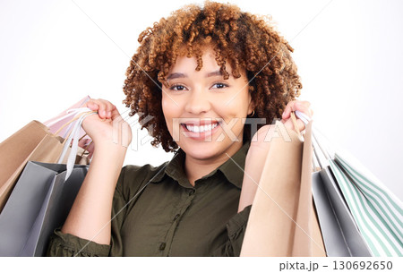 Fashion, portrait or happy black woman with shopping bags from boutique sale isolated on white background. Smile, face or excited customer studio with retail products on discount or offers in studio Fashion, portrait or happy black woman with shopping bags from boutique sale isolated on white background. Smile, face or excited customer studio with retail products on discount or offers in studio 130692650