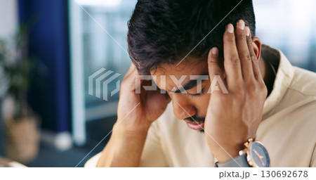 Headache, frustrated and tired business man or overworked employee in office. Stress, burnout and professional person with hand on head for fatigue with pain, crisis or fail and mistake at workplace 130692678