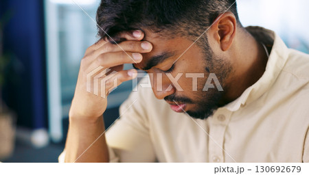 Tired, headache and frustrated business man or overworked employee in office. Stress, burnout and professional person with hand on head for fatigue with pain, crisis or fail and mistake at workplace 130692679