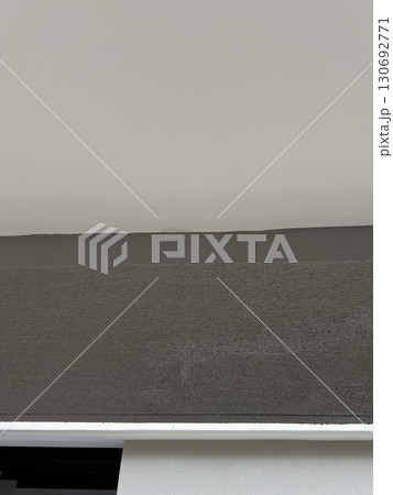 Abstract background of wall texture showing damage from water leak in ceiling of modern home interior. simple and minimalist view of serious problem Abstract background of wall texture showing damage from water leak in ceiling of modern home interior. simple and minimalist view of serious problem 130692771