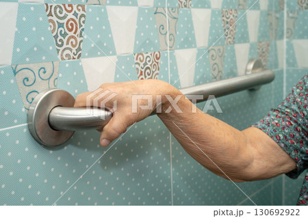 Asian elderly woman patient use toilet bathroom handle security in nursing hospital, healthy strong medical. 130692922