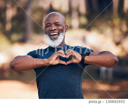 Portrait, heart fitness and senior man self care, cardiology and workout health support in forest or outdoor running. Face of sports person with retirement love hands in the woods or nature wellness 130692933