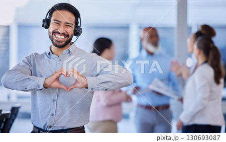 Call center, heart hands and portrait of customer service agent with headset, mockup and smile on face in office. Smiling business man, help desk consultant with care and confidence at crm agency job 130693087