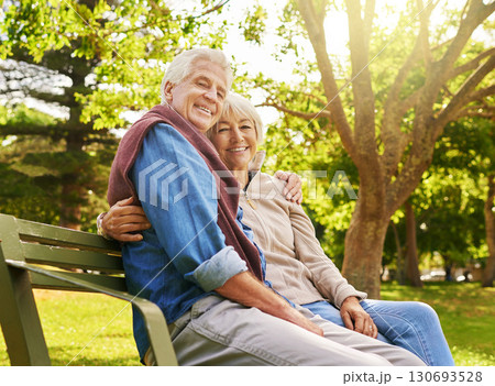 Old couple hug in portrait, relax in the park with smile, happiness together with bonding in nature, love and retirement. Happy, man and woman with travel, relationship with marriage and commitment 130693528