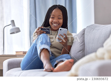 Online shopping, credit card and black woman with phone on sofa for financial banking, ecommerce and fintech. Happy customer in house for mobile finance, digital money and fast food delivery payment 130693672