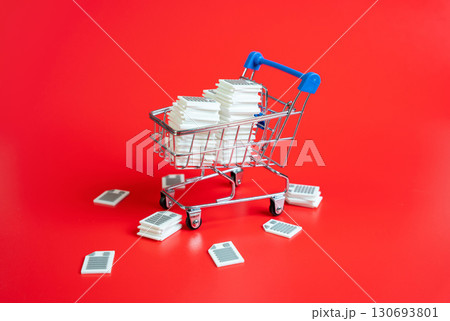 Shopping cart filled with documents and papers. Concept of excessive regulation, complex rules, and administrative barriers. Used for bureaucracy, tax policy, and compliance. Shopping cart filled with documents and papers. Concept of excessive regulation, complex rules, and administrative barriers. Used for bureaucracy, tax policy, and compliance. 130693801