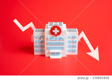 Hospital with down arrow. Symbol of reduced healthcare access, medical closures, and budget shortages. Suitable for health reform, crisis, and social policy themes. 130693808