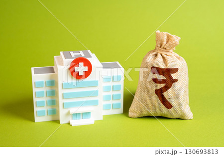 Hospital with rupee money bag. Symbol of healthcare financing, treatment costs, and medical system strain. Suitable for insurance, public health, and economic policy. 130693813