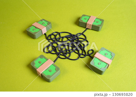 Money connected by tangled lines. Financial crime, corruption. Money laundering, fraud, banking risks, and compliance control. 130693820