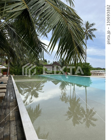 Maldives Paradise: Infinity Pool Overlooking Ocean and Beach 130693882