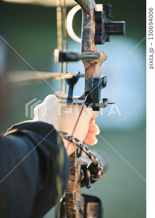 Sports archer, hands and bow and arrow training for archery competition, athlete challenge or girl field practice. Shooting, talent and competitive woman focus on precision, aim or outdoor objective Sports archer, hands and bow and arrow training for archery competition, athlete challenge or girl field practice. Shooting, talent and competitive woman focus on precision, aim or outdoor objective 130694006