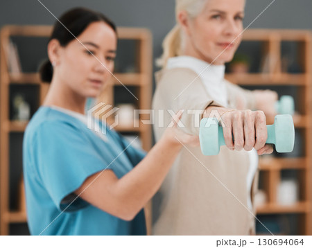 Senior woman, dumbbell and physiotherapy rehabilitation nurse help for fitness and muscle support. Healthcare physiotherapist with hand of elderly patient for physical therapy and stretching exercise Senior woman, dumbbell and physiotherapy rehabilitation nurse help for fitness and muscle support. Healthcare physiotherapist with hand of elderly patient for physical therapy and stretching exercise 130694064