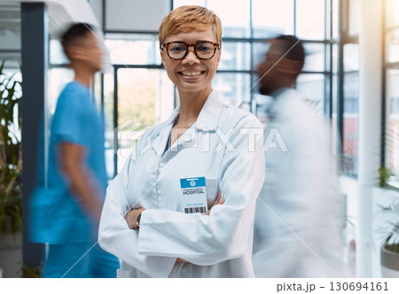 Portrait, doctor and black woman in a busy hospital standing arms crossed with motion blur. Healthcare, leadership and trust with a female medicine professional in a clinic for health treatment Portrait, doctor and black woman in a busy hospital standing arms crossed with motion blur. Healthcare, leadership and trust with a female medicine professional in a clinic for health treatment 130694161