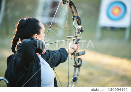 Archery woman, target and bow and arrow training for outdoor sports, athlete challenge or girl field competition. Shooting goals, talent and competitive archer focus on precision, aim or objective 130694162