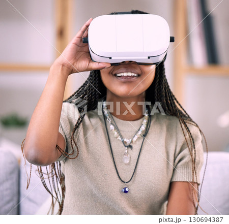 Future, virtual reality glasses and black woman in lounge, esports and connection for metaverse. Futuristic, African American girl with vr, smile and 3d gaming in living room or stress relief Future, virtual reality glasses and black woman in lounge, esports and connection for metaverse. Futuristic, African American girl with vr, smile and 3d gaming in living room or stress relief 130694387