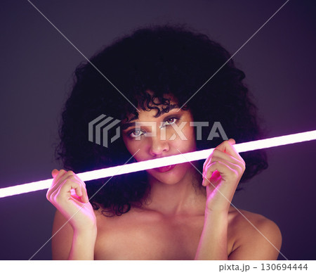 Purple light, woman and beauty portrait in studio with neon uv fashion for makeup cosmetics. Face of aesthetic gen z model black person on dark background for natural art glow on skin or afro hair 130694444