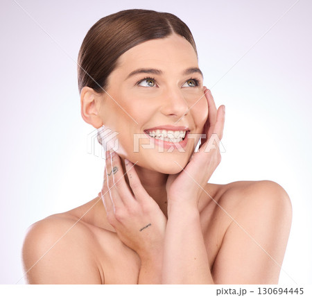 Skincare, happy and hands on face of woman in studio for grooming, cosmetics and wellness on gradient background. Beauty, smile and girl model relax in luxury, makeup and skin dermatology routine 130694445