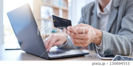 Hands, laptop and credit card for ecommerce, online shopping or banking on the office desk. Hand of business person or shopper typing on computer for internet purchase, bank app or transaction Hands, laptop and credit card for ecommerce, online shopping or banking on the office desk. Hand of business person or shopper typing on computer for internet purchase, bank app or transaction 130694553