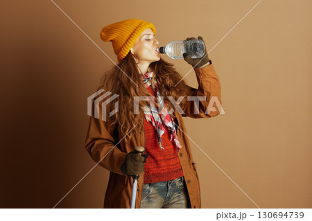 Hiker Woman Hydrating During an Autumn Trek Hiker Woman Hydrating During an Autumn Trek 130694739