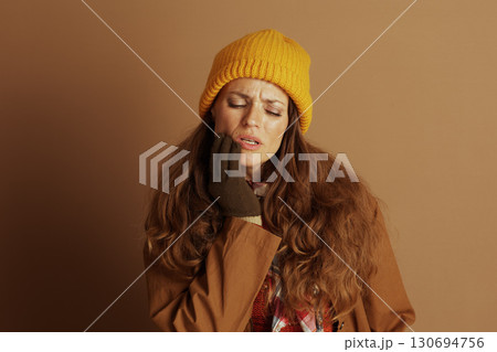 Woman with Pained Expression, Hand to Cheek 130694756