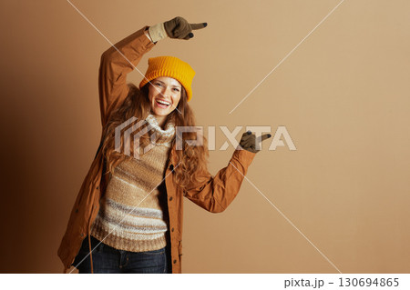 Energetic Woman in Winter Fashion Pointing Energetic Woman in Winter Fashion Pointing 130694865