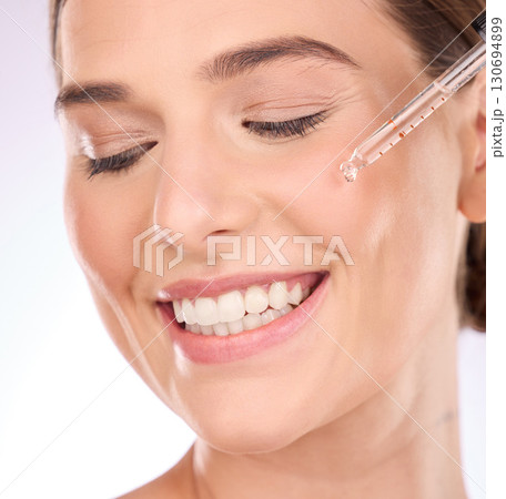 Oil, woman and skin or face for beauty and skincare with dermatology cosmetics product. Aesthetic model person teeth smile for serum dropper with collagen for facial glow self care makeup results Oil, woman and skin or face for beauty and skincare with dermatology cosmetics product. Aesthetic model person teeth smile for serum dropper with collagen for facial glow self care makeup results 130694899