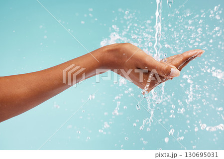 Hands, woman and water splash for washing, skincare and healthy beauty on studio background. Closeup of person cleaning body, drops and palm in bathroom for wellness, shower and aesthetic self care 130695031