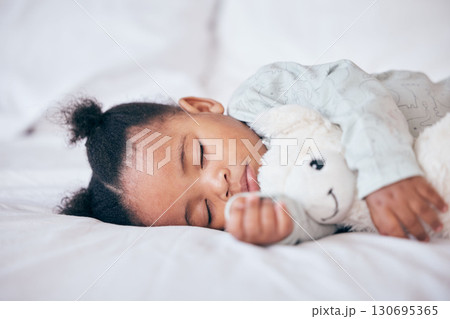 Black child, baby and sleeping with toy in bedroom, home and nursery for peace, calm nap and dreaming. Tired young girl kid asleep with teddy bear for resting, break and healthy childhood development 130695365