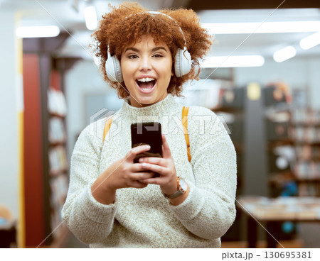 University student, woman and phone for texting, library and headphones for streaming music, happy and online. Gen z girl, smartphone and social media app for chat communication on internet at campus 130695381