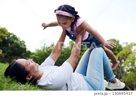 Black family, park and flying with a woman and girl having fun together while bonding on grass outdoor. Kids, love and nature with a mother and daughter playing in a green garden outside in summer Black family, park and flying with a woman and girl having fun together while bonding on grass outdoor. Kids, love and nature with a mother and daughter playing in a green garden outside in summer 130695417