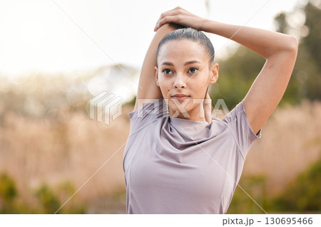 Sports, fitness and woman stretching arms in nature to get ready for workout, training or exercise. Thinking, health or young female athlete stretch and warm up to start exercising, cardio or running Sports, fitness and woman stretching arms in nature to get ready for workout, training or exercise. Thinking, health or young female athlete stretch and warm up to start exercising, cardio or running 130695466