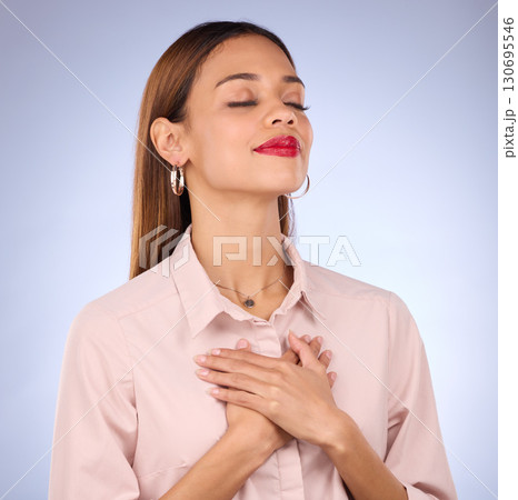 Hands on chest, heart and self love with woman against studio background, content and with gratitude for health. Wellness, young female and calm with eyes closed, inner peace and zen with mindfulness 130695546