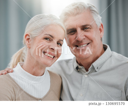 Portrait, love and lifestyle with a senior couple hugging in the living room of their house together. Smile, face or trust with a happy mature man and woman bonding while enjoying retirement at home Portrait, love and lifestyle with a senior couple hugging in the living room of their house together. Smile, face or trust with a happy mature man and woman bonding while enjoying retirement at home 130695570