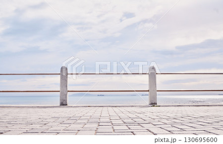 Morning, beach and view of ocean from the promenade of the water, nature and landscape in Italy. Travel, natural and peaceful tourism site by the sea to relax and be calm on the coast for traveling 130695600