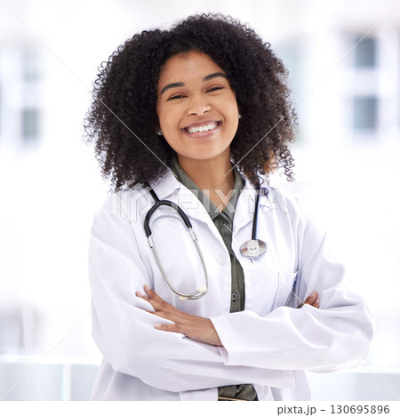Doctor, black woman and smile portrait for healthcare with life insurance in hospital for wellness. Face of happy medical professional with arms crossed with pride for career, motivation and medicine 130695896