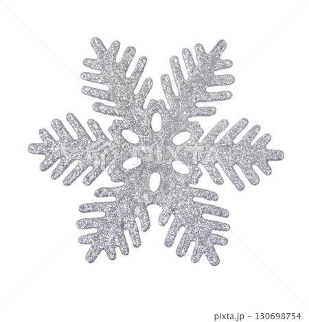 A Christmas decorative tree ornament in the shape of a silver shiny snowflake, isolated on a white background with clipping path. Design element for Christmas card A Christmas decorative tree ornament in the shape of a silver shiny snowflake, isolated on a white background with clipping path. Design element for Christmas card 130698754