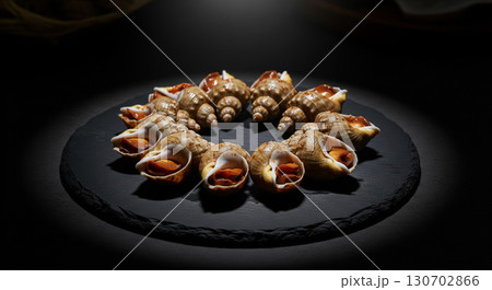 Artistic Display of Whelks on Black Plate 130702866