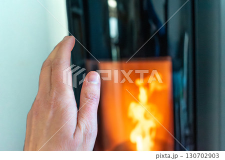Pellet stove burning with flame in a living room 130702903