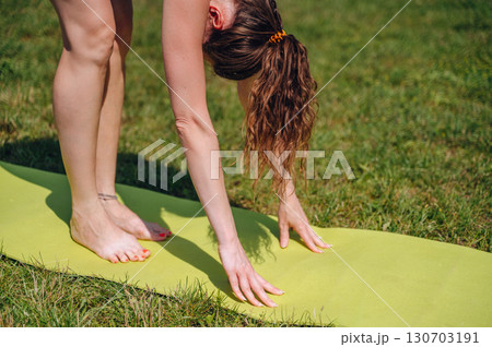 Young beauty girl doing yoga pose on nature background Young beauty girl doing yoga pose on nature background 130703191