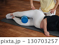 A fitness trainer demonstrates exercises to a pregnant woman. 130703257